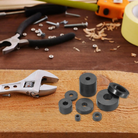 Black Rubber Spacers 1.97 OD 0.39 ID, 5 Piece Set Round Anti Vibration Bushings Washers on wood with tools background