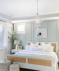 Plug In Mini Crystal Chandelier hanging in a stylish bedroom with modern decor and large windows behind the bed.