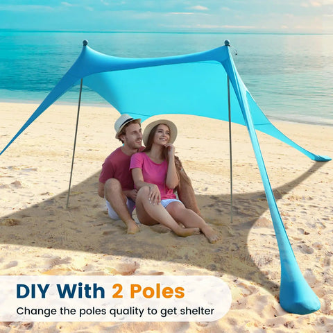 Couple sitting under a 10 X 10 Ft Beach Canopy Sun Shelter With UPF50 Plus UV Protection on a sandy beach with 2 poles.