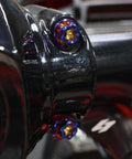 Top Shelf Titanium Handlebar Clamp Bolts And Brake Clutch Perch Screws For Heavy Duty Motorcycles, close-up view of colorful titanium fasteners.