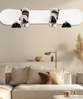 Sturdy Snowboard Wall Mount Racks Hold Four Boards Securely for Garage or Bedroom Displays with Heavy Duty ABS Holders and Skateboard Storage Hooks to Keep Your Shred Game Strong and Clutter Free - snowboard mounted on a wall above a couch.