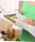 A person using 100 Pack White EPE Foam Pouches For Moving And Shipping Sweet Protective Cushioning Wrap Bags For Fragile Plates And Delicate Glassware to wrap a framed photo.