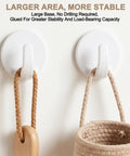 Two Eight Piece White Peel And Stick Wall Hooks displayed with woven bag and wooden spoon, demonstrating strong adhesive hold.