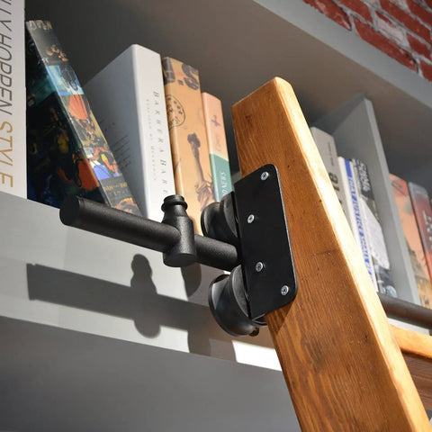 Built Tough Sliding Barn Door Track Kit With Rust Proof Extension Rail And Quiet Floor Roller For Quick Home Or Library Setup Smooth Glide Motion Reliable Structure Handles Three Hundred Thirty Pounds. Close-up of rail attachment to a wooden ladder.