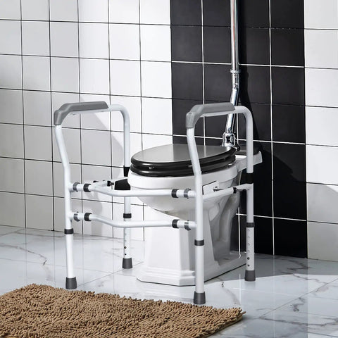 Heavy Duty Adjustable Toilet Safety Frame And Rail For Elderly Bathroom Assist With Rock Solid Non Slip Grab Bars No Drama Setup Secure Stand Alone Commode Support Rack next to a commode in a bathroom.