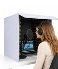Portable Vocal Booth With Foldable Soundproof Isolation Shield used by a woman with headphones in a compact setup.