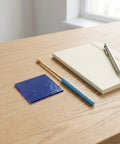 Flame Test Wire Kit With Cobalt Glass Filter Sheet, Metal Alloy Wire And Blue Glass Rods for home science experiments on wooden desk.