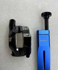 Blue aluminum Piston Press Tool for Brake Calipers next to caliper, Universal Bicycle Hydraulic Disc Brake Piston Tool.