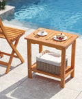 Acacia Wood Outdoor Side Table With Slatted Top And Two Tier Storage Shelf For Backyard Poolside Patio Or Indoor Use Built To Last In Natural Finish No Fuss Durability, by pool