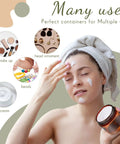 Woman applying face cream with 200 Piece 2 Oz Amber Plastic Cosmetic Jars Collection round containers for skincare.