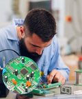 Technician using Dope Electrolytic Capacitor Kit With 24 Values And 500 Pieces for electronics repair on circuit board