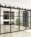 Premium Clear Tempered Glass Bypass Barn Doors 144 By 96 Inches with black carbon steel frame in modern closet setting.