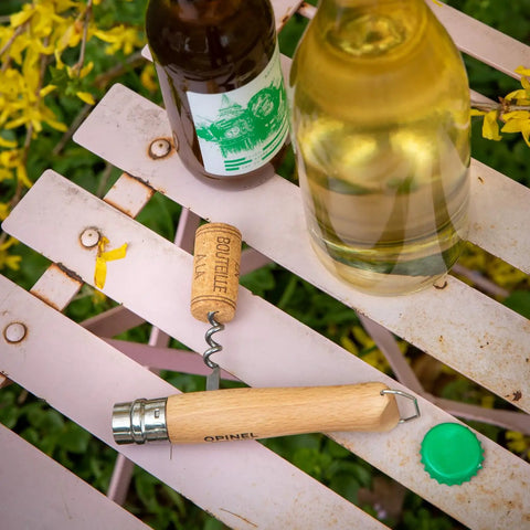 Killer Stainless Steel Folding Pocket Knife With Integrated Wine Corkscrew And Bottle Opener Solid Beechwood Handle on a picnic table.