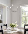 Camille 22 Inch Modern 5-Light Candle Style Chandelier With Open Frame In Brushed Nickel Finish illuminating a dining room.