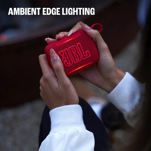 Person holding a red Palm Sized Ultra Portable Waterproof And Drop Proof Bluetooth Speaker With Deep Bass, Ambient Edge Lighting