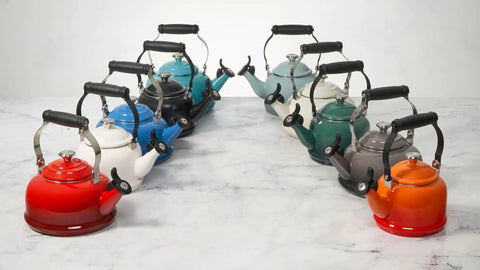 Assorted enamel on steel demi tea kettles 1.25 Qt with whistles, including Sea Salt finish model, on display