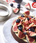 Perforated Round Tart Ring 11.25 Inch Diameter 0.8 Inch Height For Golden Crispy Tart Shells next to a fruit-topped chocolate tart