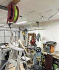 Reinforced Polyurethane 3/8 Inch ID Air Hose, 100 Ft, 300 PSI, mounted on reel in woodworking shop with high flow quick coupler.