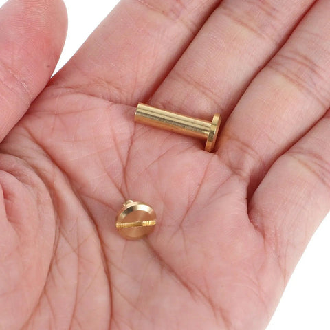 Solid Copper Binding Barrels And Screws For Scrapbooks And Photo Albums Heavy Duty Metal Rivet Replacement Kit in hand.