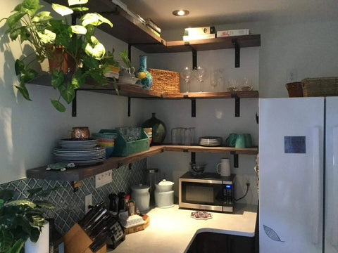 Heavy Duty Industrial Floating Shelf Wall Brackets For True 10 Inch Lumber Boards supporting kitchen shelves with dishes and glassware.