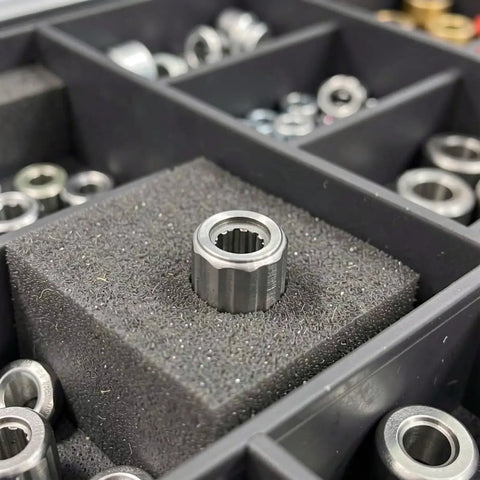Four Piece Badass One Way Needle Bearing Set With 8mm Bore And 14mm Outer Diameter resting in foam, showcasing steel material and design.