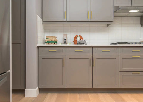 Modern kitchen with 25 Pack 5 Inch Square Cabinet Handles In Brushed Brass Finish Stainless Steel Kitchen Hardware Pulls With 5 Inch Hole Center For Cabinets Gold Durable DIY Drawer Wardrobe Updates installed on gray cabinets.