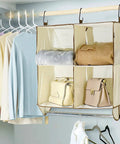 Total Closet Game Changer Hanging Purse Organizer for Wardrobe dustproof handbag storage rack with handbags and sweaters.