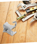 Rock Solid Heavy Duty Girder Clamp Hooks With Pipe Support Brackets For Warehouse Shelving And Garage Storage Racks on wooden surface with tools.