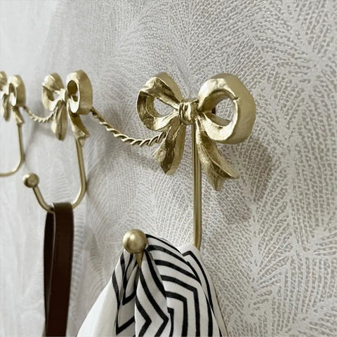 Kickass Heavy Duty Wall Mounted Coat Hook Bulletproof Metal Clothes Hanger with decorative bows, ideal for stylish organization.