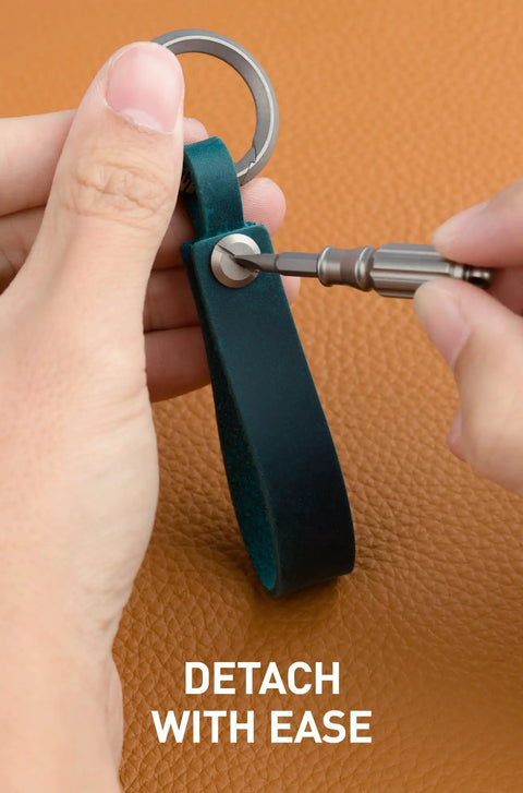 Top Shelf Crazy Horse Leather EDC Keychain Strap With Aerospace Titanium Key Ring For Car Keys being detached with a tool.