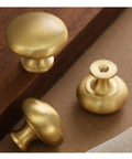 Gold Cabinet Knobs 2 Pack, Solid Brass Round Drawer Knobs for kitchen cabinets and furniture, 30mm diameter shown on wood surface.