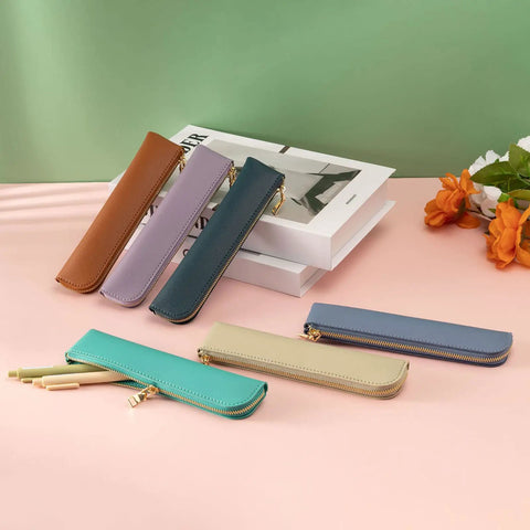 Purple Leather Pencil Case For Adults Slim Soft Pen Bag With Zipper placed on a table, with multiple color variations displayed.