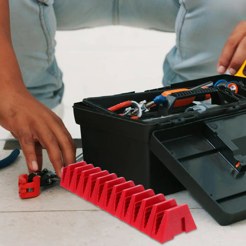 Red modular wrench organizer tray beside a toolbox on a workbench, designed for quick access in DIY storage solutions.