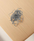 Tough as Nails Plastic Welding Rods and Hot Melt Staples Kit with 100 Pieces of 0.8 mm Auto Bumper Repair Wire pile on wooden surface.