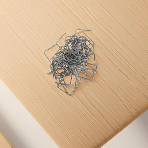 Tough as Nails Plastic Welding Rods and Hot Melt Staples Kit with 100 Pieces of 0.8 mm Auto Bumper Repair Wire pile on wooden surface.