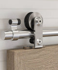 Top Mount Sliding Barn Door Hardware Kit Built Tough With Heavy Duty Stainless Steel Track And Slick Ball Bearing Rollers For Single Doors That Move Smooth As Butter Up To Forty One Inch Wide close-up of stainless steel track and roller system on wood panel.