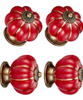 Hand Painted Red Ceramic Pumpkin Cabinet Knobs Set Of Four With Steel Screws For Kitchen Drawers And Vanities viewed from different angles.