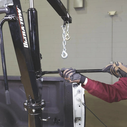 Beast Mode Hydraulic Pickup Truck Crane With 360 Degree Pivot And Integrated Hand Winch in use, showing the handle and hook.