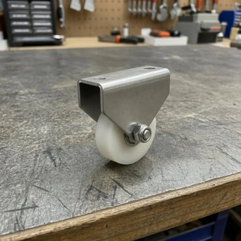 Built Tough Double Hole Bracket Pulley With Nylon Wheel Track Rolling On Precision Bearing Axle For Hassle Free Mounting And Silky Smooth Tracking On Shop Floor Or Custom Automation Build 38mm Flat on workbench