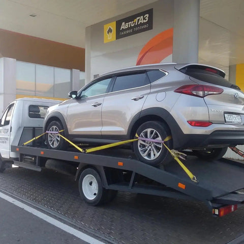 Car secured on trailer using 4 Pack Heavy Duty Car Trailer Tie Down Straps Set With 2 Inch By 10 Foot Ratchet Straps J Hooks