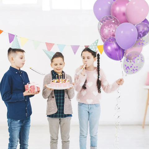 Three children celebrating with a birthday cake and Sixty Eight Piece Pink And Purple Balloons Set 12 Inch Metallic Latex Party Decor.