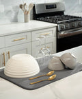 Top Shelf Microfiber Dish Drying Mat Extra Large 18 X 24 Inch Countertop Pad with wet plates and glasses on a grey mat.