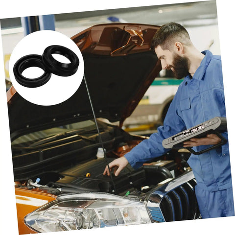 Pro Grade Tire Changer Cylinder Seal Kit With High Precision Oil Seals For Air Tight Performance Replacement Parts Set For Tire Changer Machines Minimizes Air Loss And Leaks Durable Plastic Seal Ring Pack Of 4 black rings shown with mechanic
