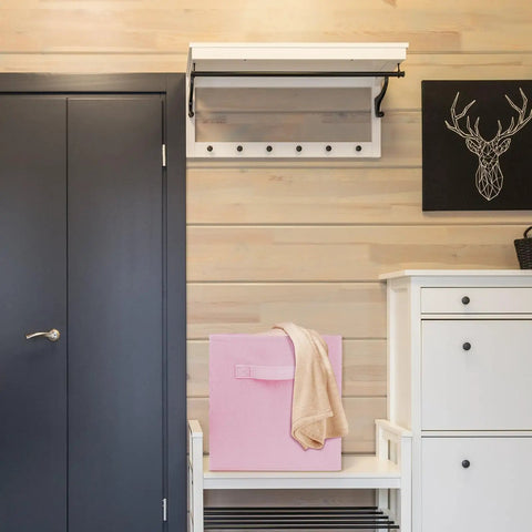 Super Durable Collapsible Storage Cubes 10 5 Inch Foldable Fabric Bins in pink on a shelf next to a towel in a stylish room.