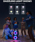 Ultimate Party Bluetooth Speaker With 240W Peak Power, Dazzling Light Show on beach at night with dancing group