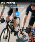Two cyclists with Outdoor Bluetooth Speaker with IPX7 Waterproof Rugged Build, Compact Yet Loud, attached to handlebars using TWS.