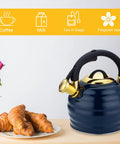 Stovetop Whistling Tea Kettle 3.2 Quart Stainless Steel Teakettle With Heat Proof Ergonomic Handle next to croissants on a table.