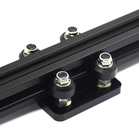 Top Shelf Pom V Slot Wheels And Pulleys Kit With Double Bearings Plus Hexagonal Eccentric Posts And Round Spacers For Fly Performance Aluminum Extrusion 3D Printer Mods, close-up of black POM cups on aluminum rail.