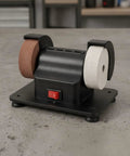 Badass Dual Wheel Bench Grinder With Sturdy Rubber Footed Base. Compact benchtop sharpening tool with brown and white wheels.