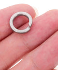 Top Shelf Stainless Steel Spring Lock Washers M8 100 Piece Set held in hand, showing split design for securing bolts and screws.